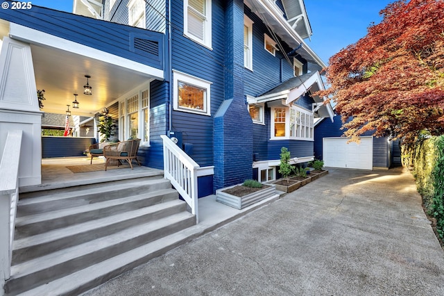 3136 NE 41st Ave, Portland, OR 97212 - view of side of property with covered porch, an outdoor structure, and concrete driveway