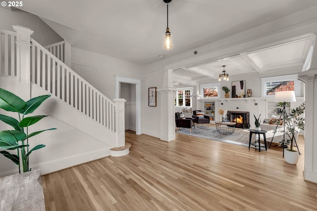 3136 NE 41st Ave, Portland, OR 97212 - living area with light wood-style floors, stairway, a glass covered fireplace, baseboards, and beam ceiling