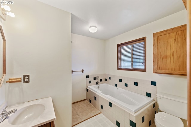 bathroom featuring tile patterned floors, vanity, toilet, and a bath