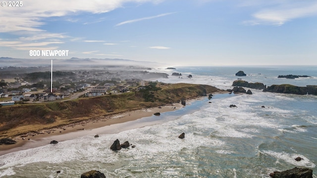 drone / aerial view featuring a water view and a view of the beach