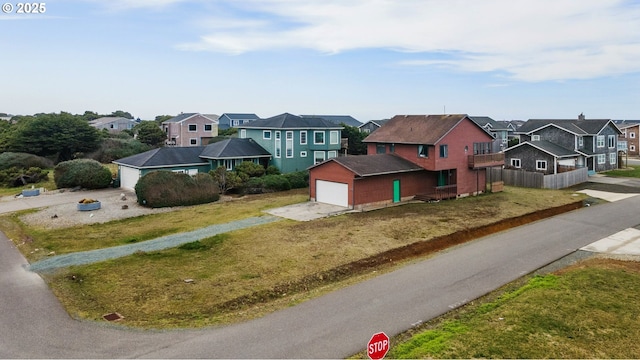 exterior space featuring a residential view, driveway, and a front yard