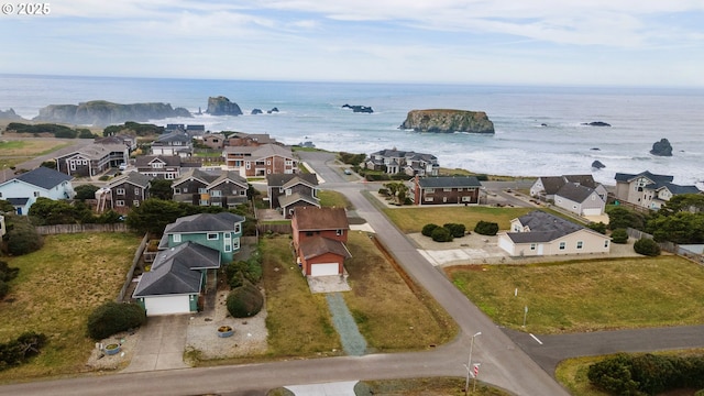 drone / aerial view featuring a residential view and a water view