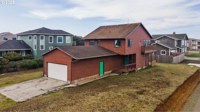 view of front facade featuring a residential view, fence, and a front lawn