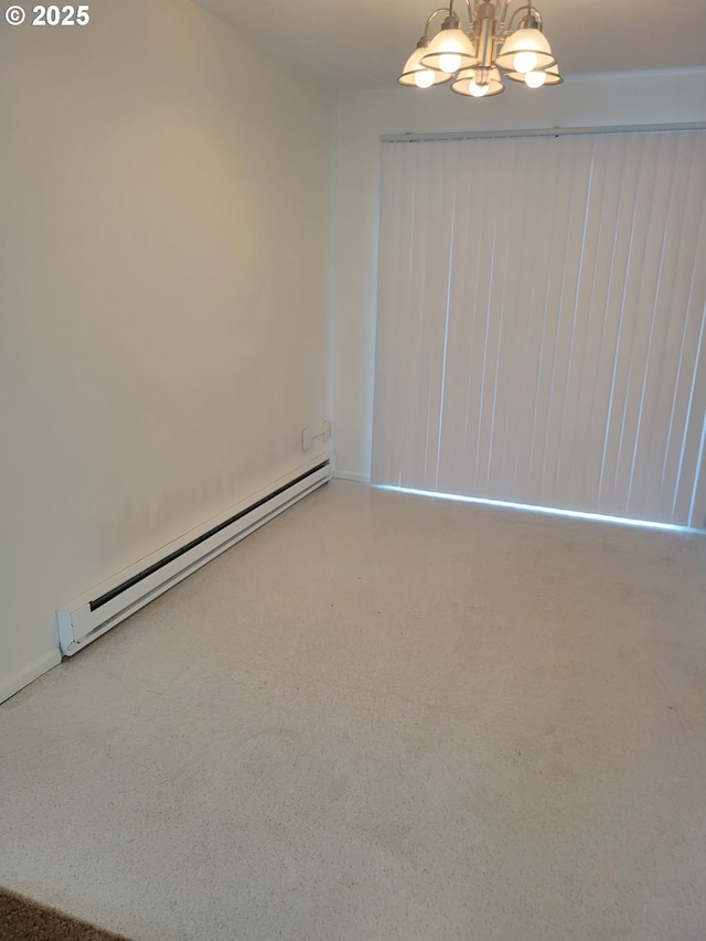 unfurnished room featuring an inviting chandelier and baseboard heating