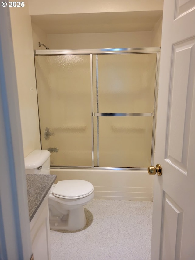 full bathroom featuring vanity, combined bath / shower with glass door, and toilet