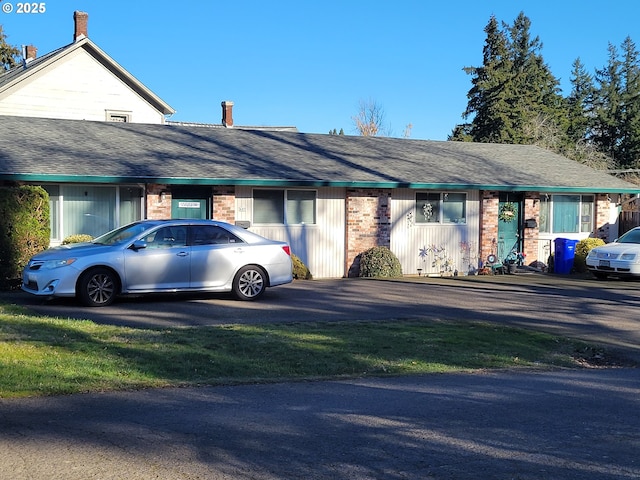 view of car parking featuring a lawn