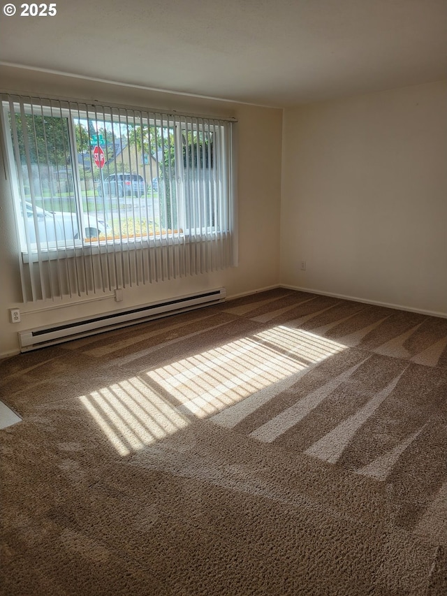 carpeted empty room featuring a baseboard radiator