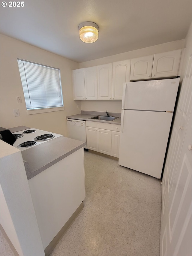 kitchen featuring white cabinetry, sink, and white appliances