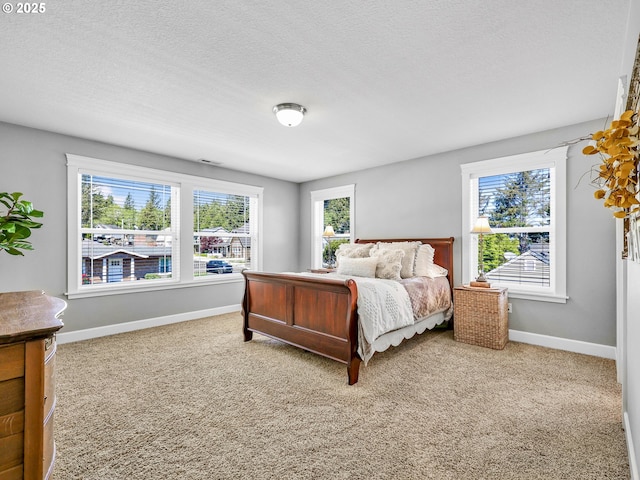 carpeted bedroom featuring baseboards and a textured ceiling
