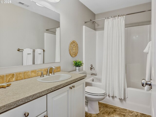 bathroom with shower / tub combo, vanity, and toilet
