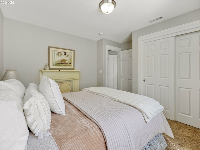 bedroom with a closet and light carpet