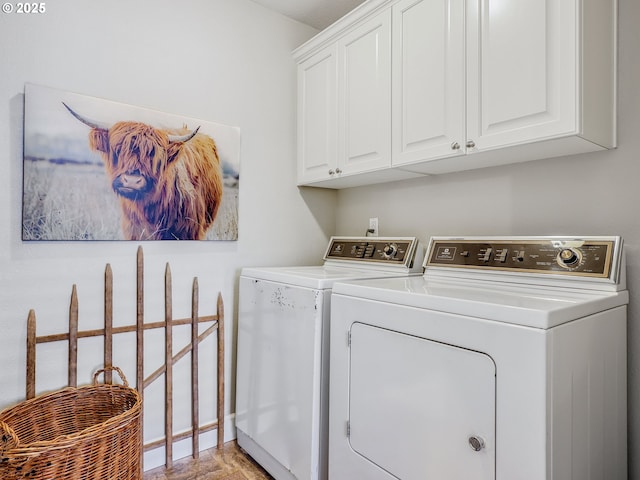 clothes washing area featuring separate washer and dryer and cabinet space