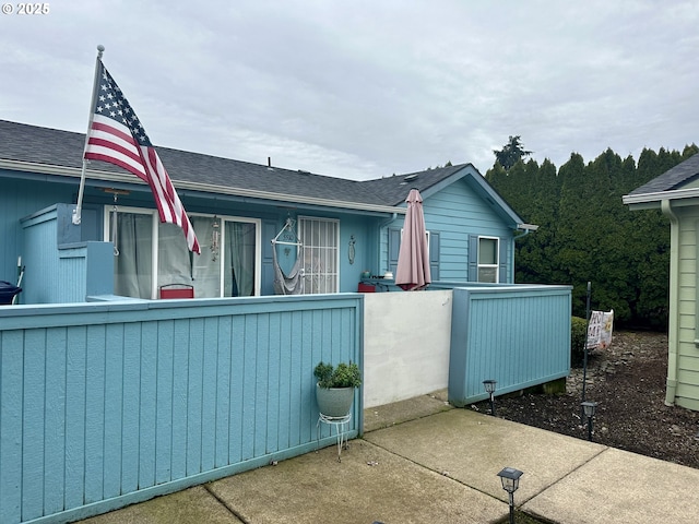5510 E St, Springfield, OR 97478 - view of side of home with a fenced front yard and roof with shingles