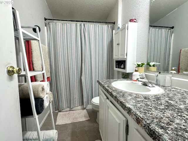 5510 E St, Springfield, OR 97478 - bathroom featuring vanity, toilet, a textured ceiling, tile patterned flooring, and a textured wall