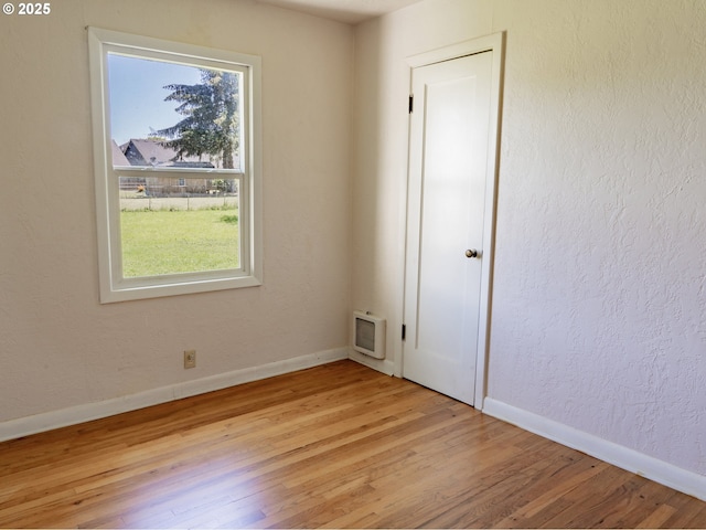 empty room with light hardwood / wood-style flooring