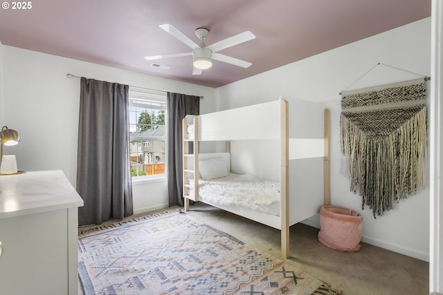 carpeted bedroom featuring visible vents, a ceiling fan, and baseboards