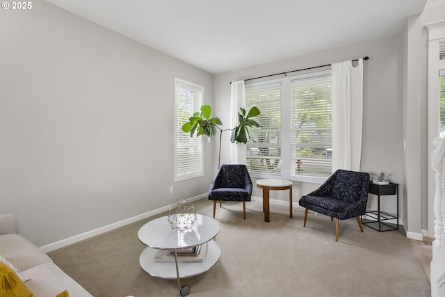 living area featuring carpet floors and baseboards