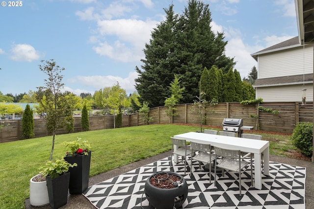 view of patio with outdoor dining space, a fenced backyard, and a grill