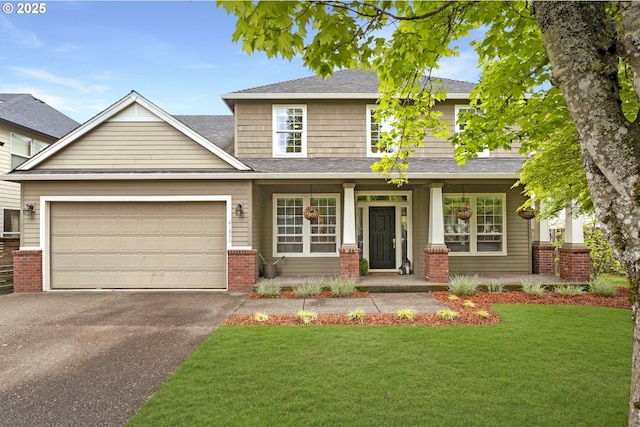 view of front of house with an attached garage, aphalt driveway, a front yard, and a porch