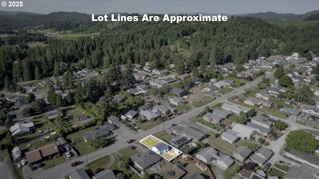 1636 Maple St, Myrtle Point, OR 97458 - aerial view of property and surrounding area with a forest, mountains, and nearby suburban area