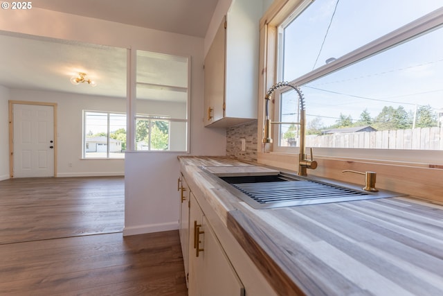 1636 Maple St, Myrtle Point, OR 97458 - kitchen with plenty of natural light, white cabinets, a sink, and baseboards