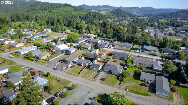 1636 Maple St, Myrtle Point, OR 97458 - aerial view of property and surrounding area with a forest, mountains, and nearby suburban area
