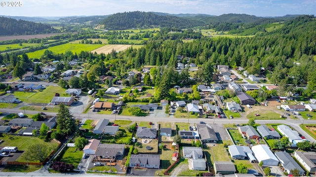 1636 Maple St, Myrtle Point, OR 97458 - aerial view of property and surrounding area with a mountainous background, nearby suburban area, and a heavily wooded area