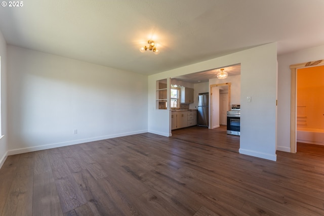 1636 Maple St, Myrtle Point, OR 97458 - unfurnished living room with dark wood finished floors, baseboards, and a sink
