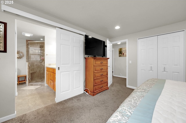 bedroom featuring light carpet, ensuite bathroom, recessed lighting, a closet, and baseboards