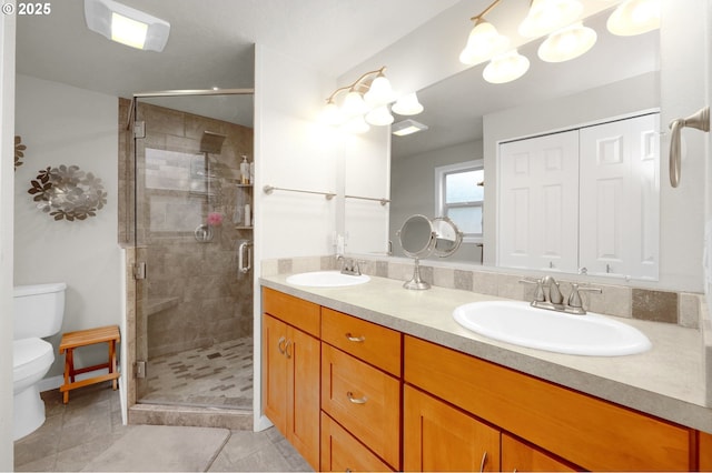 full bathroom featuring tile patterned floors, toilet, double vanity, and a sink