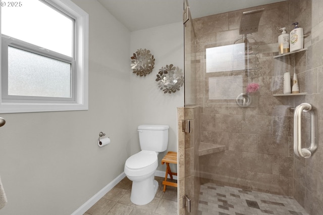 full bath with tile patterned flooring, a shower stall, toilet, and baseboards