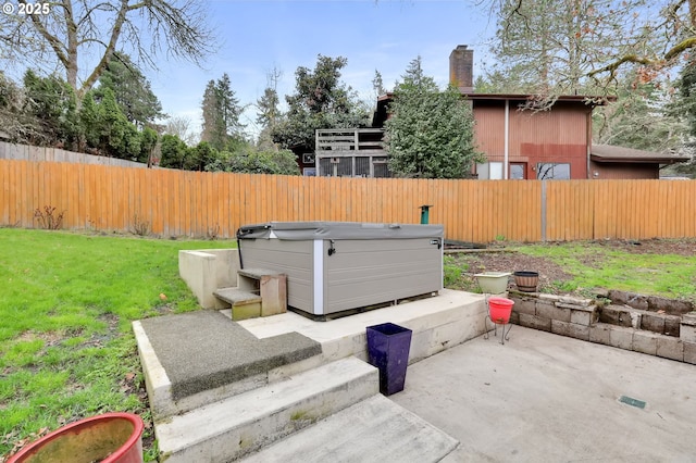 exterior space featuring a fenced backyard and a hot tub