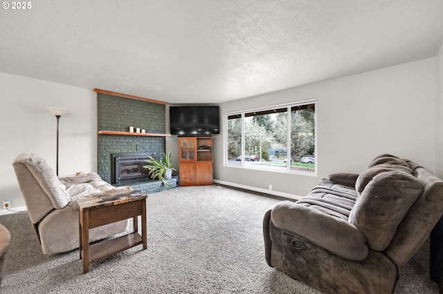 carpeted living area featuring a brick fireplace, baseboards, and a textured ceiling