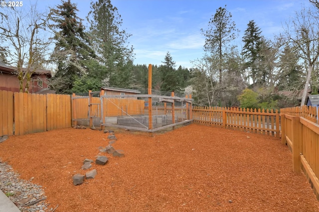 view of yard with an outbuilding and a fenced backyard