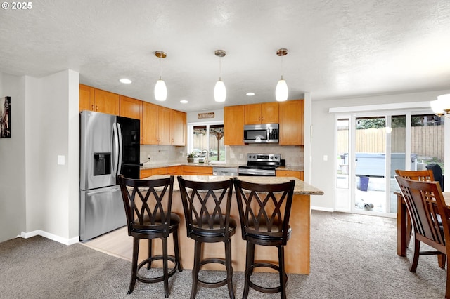 kitchen with light carpet, decorative backsplash, plenty of natural light, and appliances with stainless steel finishes