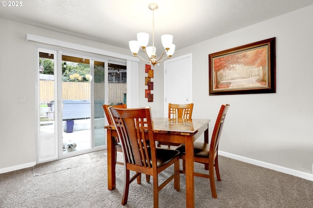 dining area featuring a notable chandelier, baseboards, and carpet floors