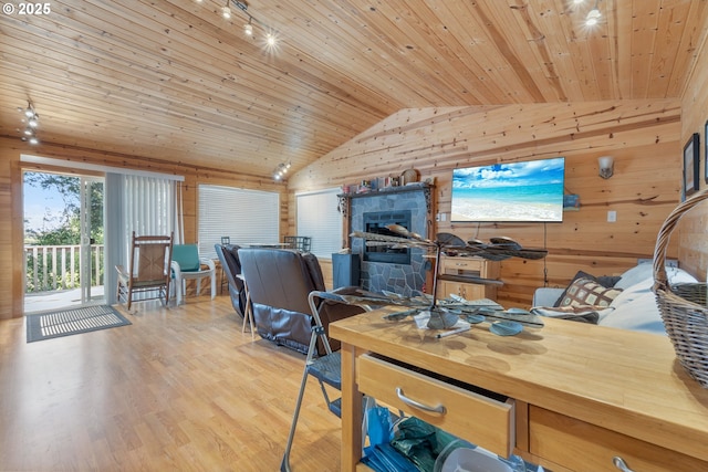 office with rail lighting, vaulted ceiling, wood ceiling, wood walls, and light wood finished floors