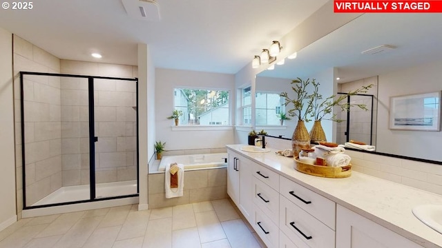 bathroom with tile patterned flooring, vanity, and plus walk in shower