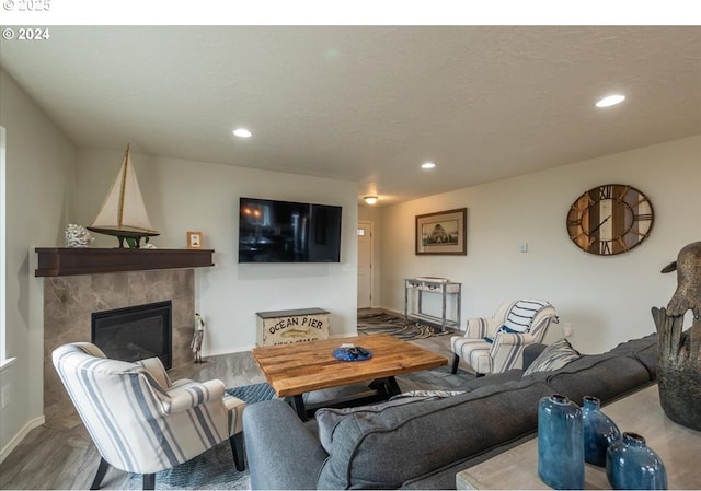 living area with a fireplace, wood finished floors, and recessed lighting