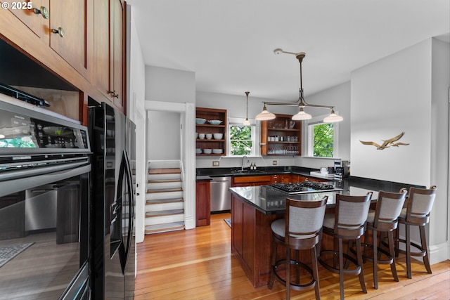 2325 A St, Forest Grove, OR 97116 - kitchen with open shelves, stainless steel appliances, dark countertops, a peninsula, and a breakfast bar