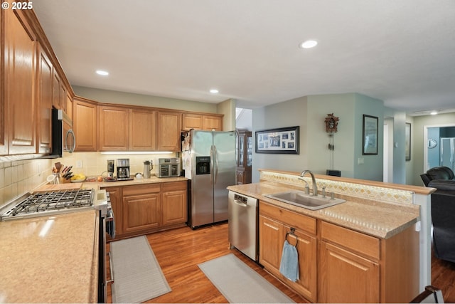 4709 SE Antelope Hills Dr, Gresham, OR 97080 - kitchen with appliances with stainless steel finishes, a sink, light countertops, light wood-style flooring, and recessed lighting