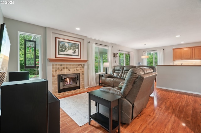 4709 SE Antelope Hills Dr, Gresham, OR 97080 - living area with light wood-style flooring, a tile fireplace, and recessed lighting