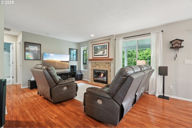 4709 SE Antelope Hills Dr, Gresham, OR 97080 - living room featuring light wood-type flooring, a tiled fireplace, baseboards, and recessed lighting
