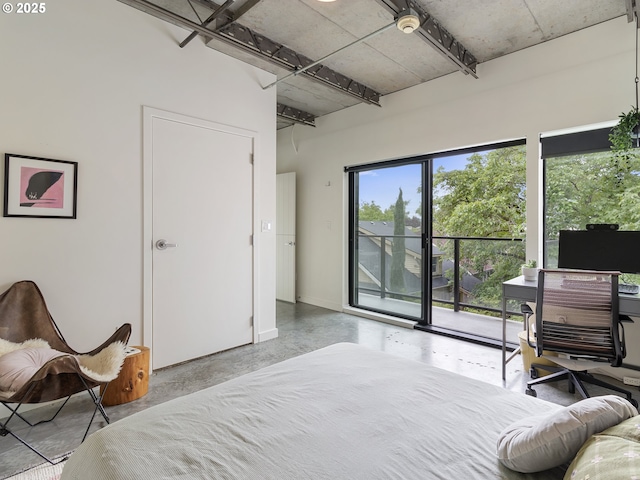 1507 SE 45th Ave Unit 308, Portland, OR 97215 - bedroom featuring access to outside, finished concrete flooring, and baseboards