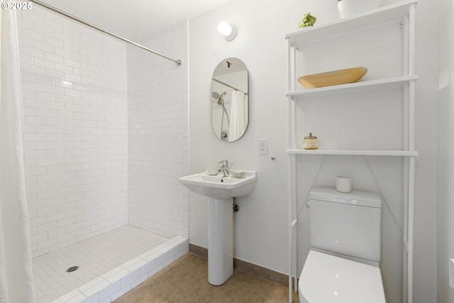 1507 SE 45th Ave Unit 308, Portland, OR 97215 - full bath with toilet, a tile shower, tile patterned flooring, and a sink