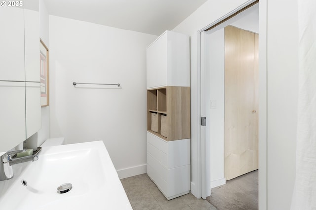1507 SE 45th Ave Unit 308, Portland, OR 97215 - bathroom featuring a sink and baseboards