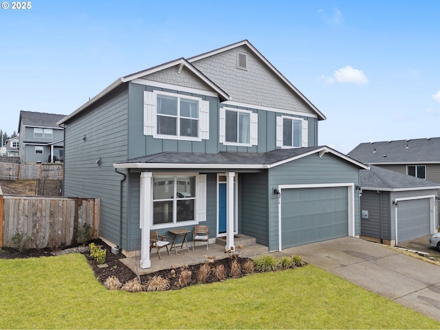 traditional-style house featuring covered porch, board and batten siding, fence, a garage, and a front lawn