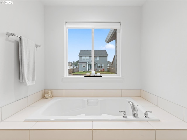 bathroom featuring tiled tub