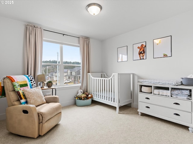 carpeted bedroom featuring a crib