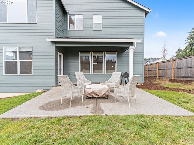 rear view of house featuring a lawn and a patio area